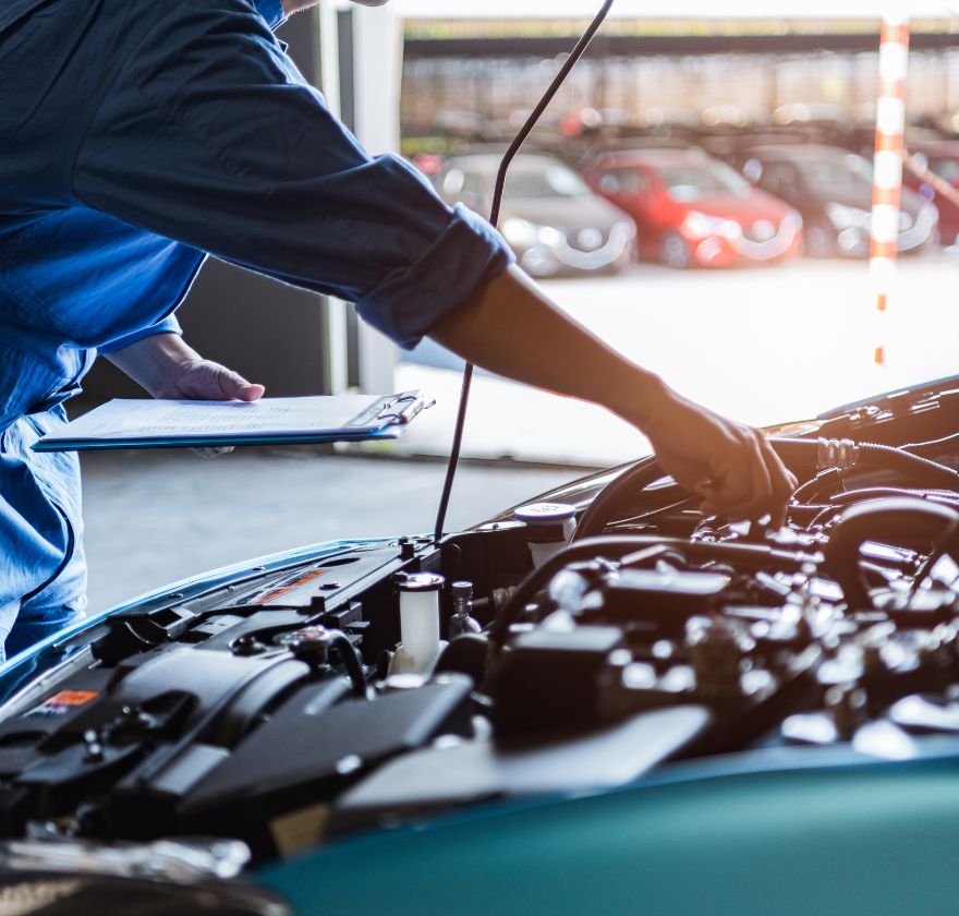 Psychosocial hazard kit for automotive and auto services — mechanic working under the bonnet in a workshop